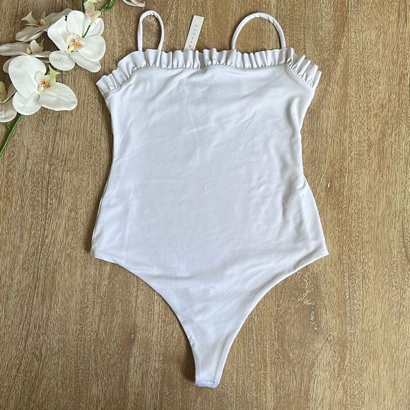 Susana Monaco Tops - Susana Monaco Ruffle String Bodysuit in Sugar Size S